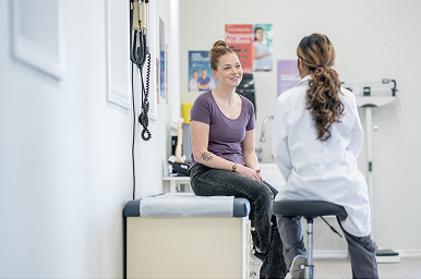 Patient discussing pregnancy care with a healthcare provider during a clinic visit