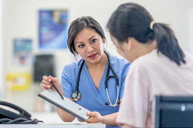 Healthcare provider discussing well-woman care and health concerns with a patient